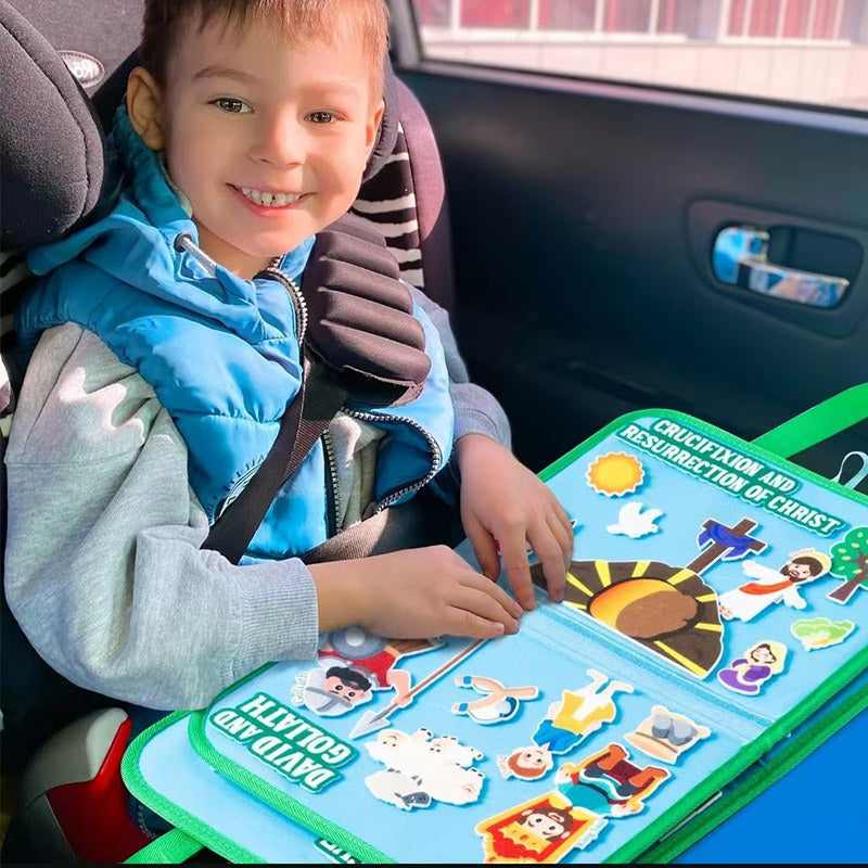 Child playing with the Bible felt board in a car seat