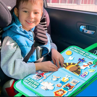 Child playing with the Bible felt board in a car seat