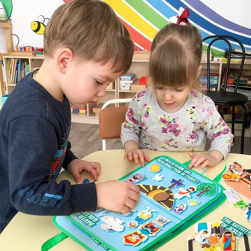 Two children building a Bible scene together on the felt board at a table