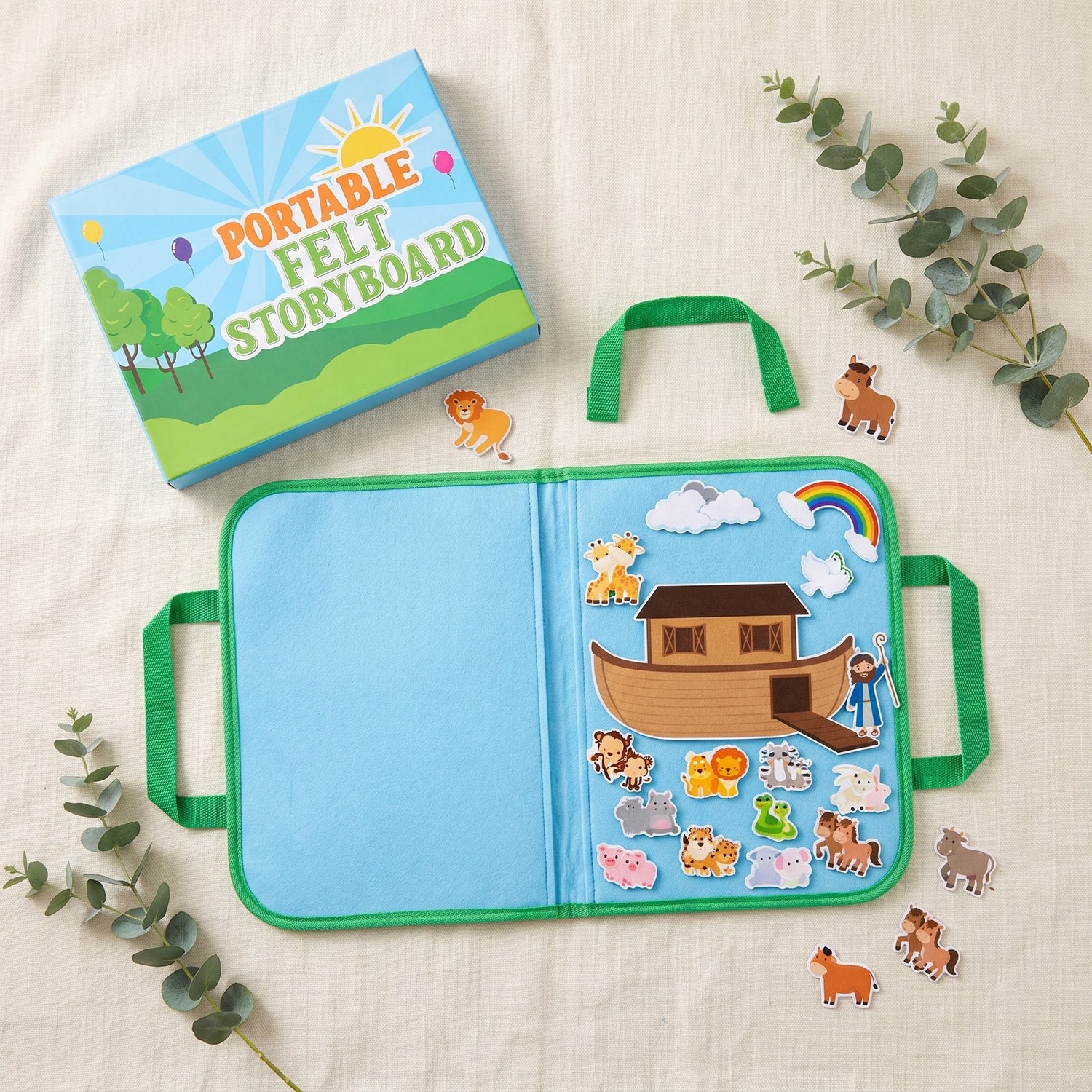 Flat lay: felt board open with a Noah's Ark scene, gift box beside it
