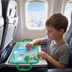 Boy playing with the felt board on an airplane tray table