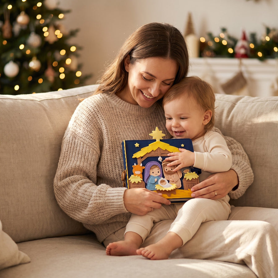 Mother and toddler on a sofa holding the handmade nativity quiet book at Christmas