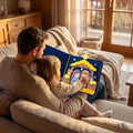 Father and young daughter on a sofa with the nativity quiet book open across their laps