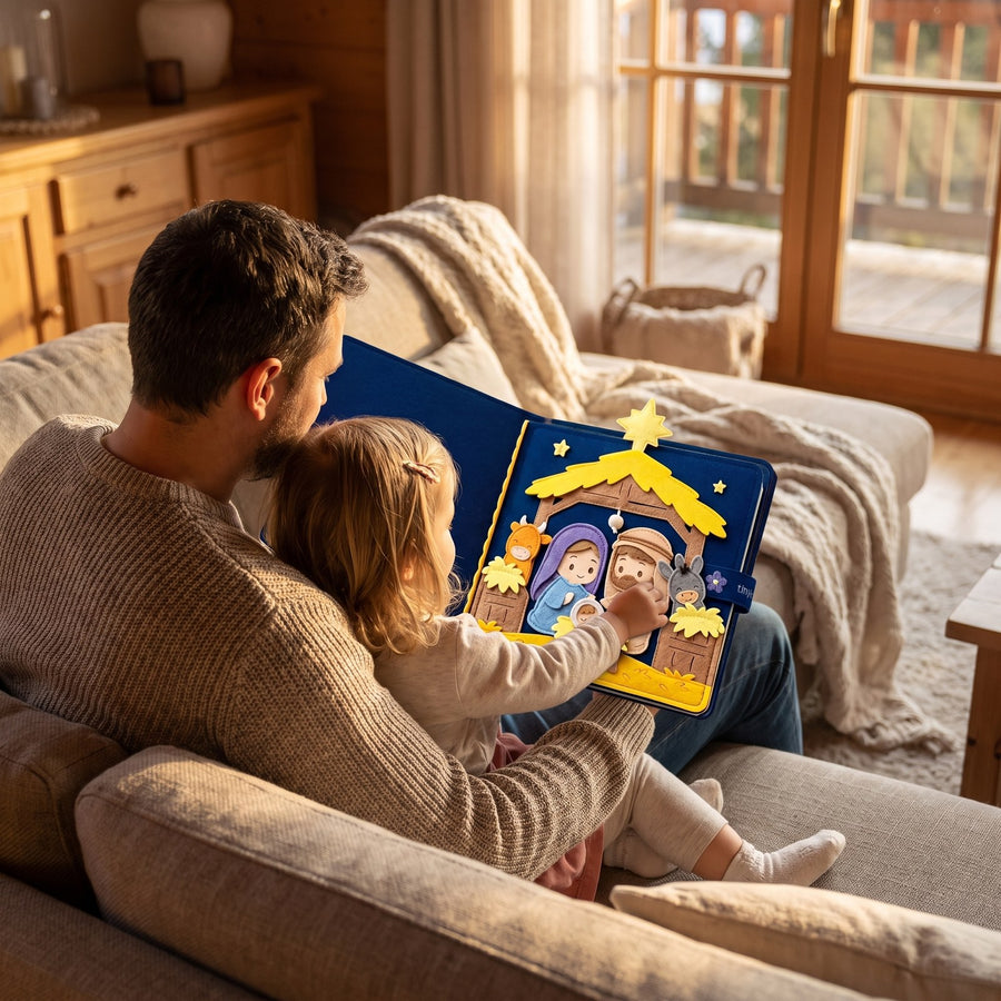 Father and young daughter on a sofa with the nativity quiet book open across their laps